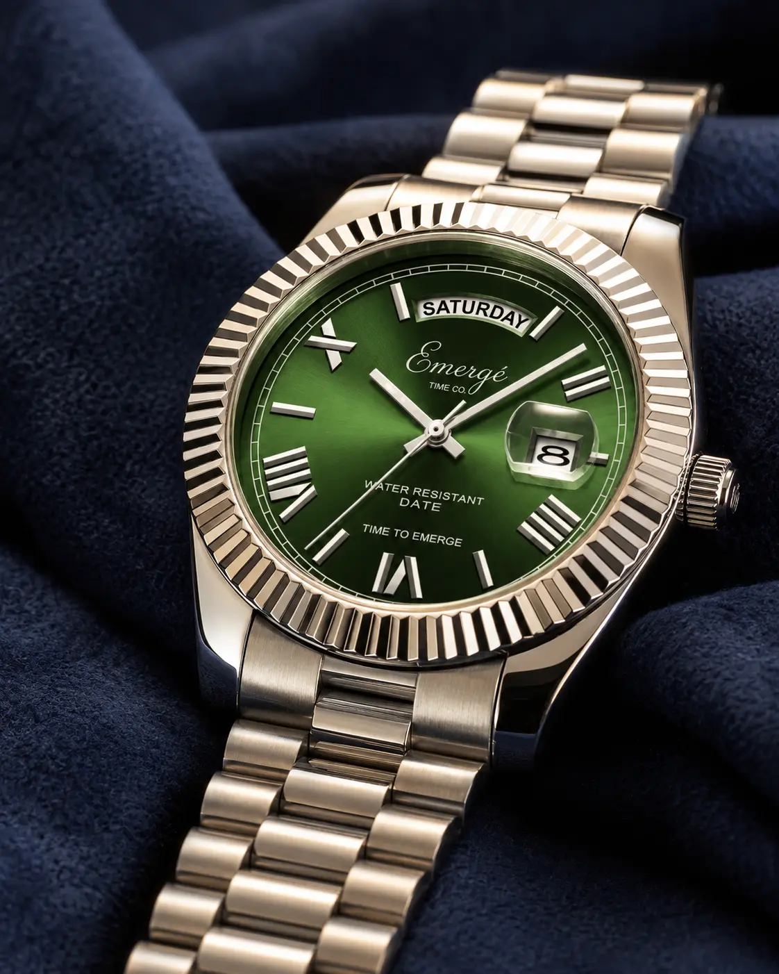 Macro view of a green-dial Emergé day-date watch on navy fabric